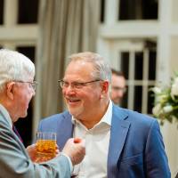 President Emeritus Don Lubbers talking with guests at the Foundation Holiday Reception